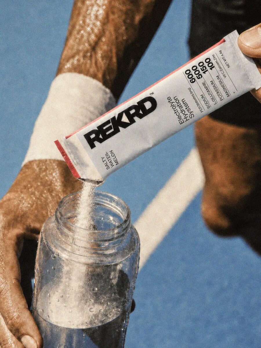 A REKRD sachet being poured into a water bottle